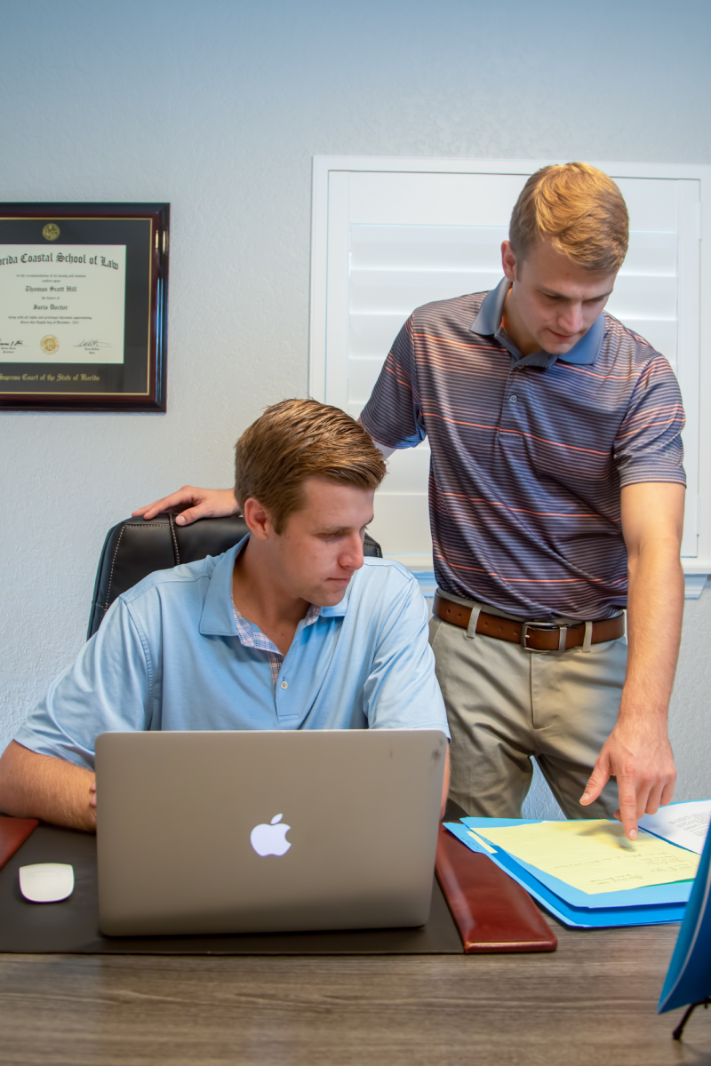 Thomas and Daniel Hill working together at the office